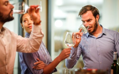 Three people sampling wine