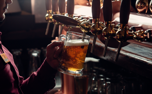 Person pouring a beer