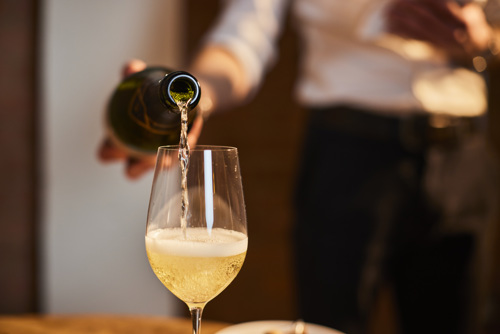 Person pouring sparkling wine