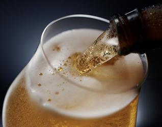 Bottled beer being poured into glass
